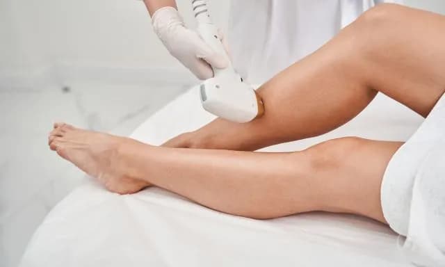 Professional performing laser hair removal procedure